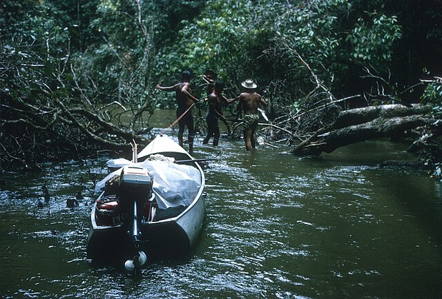 Hauling canoe up the headwaters of the Essequibo River