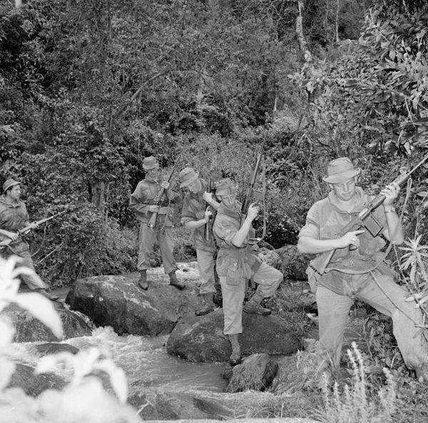 British Army patrol crossing a stream carrying FN FAL rifle (1st and 2nd soldiers from right); Sten Mk5 (3rd soldier); and the Lee–Enfield No. 5 (4th and 5th soldiers)[148]