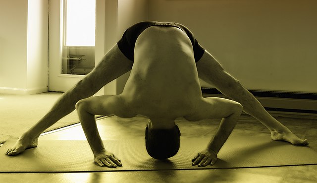Man in Marjaryasana yoga pose Stock Photo by ©nanka-photo 30228163