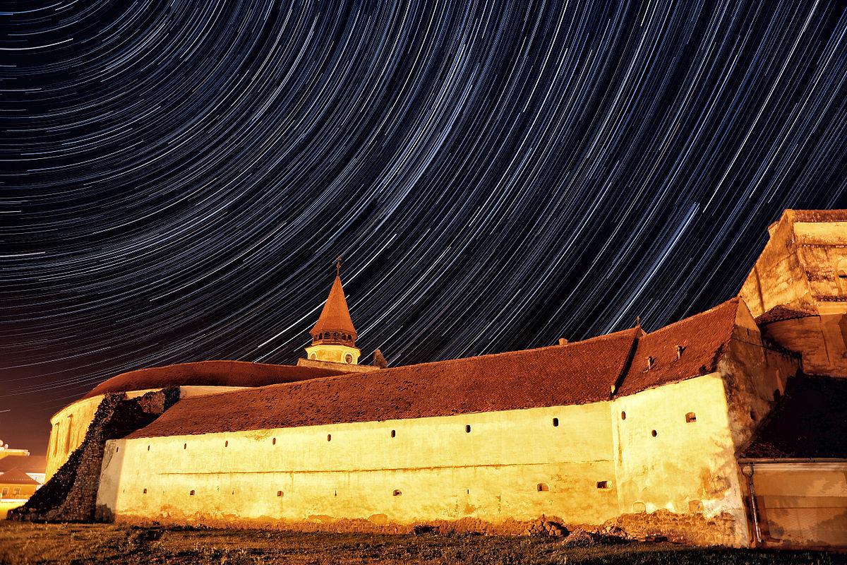 Prejmer fortified church, night view with star trails on the sky