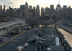 Sailors & Marines aboard the USS Bataan (LHD 5) man the rails as the ship departs New York.jpg