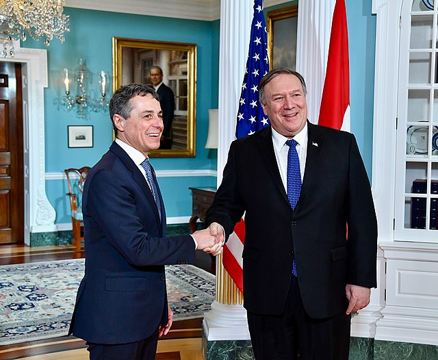 Cassis (left) shakes hands with US Secretary of State Mike Pompeo in Washington in February 2019