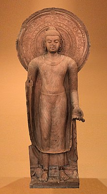 Standing Buddha in red sandstone, Mathura, Gupta Empire period, circa 5th century CE. Mathura Museum. Standing Buddha Installed by Buddist Monk Yasadinna - Circa 5th Century CE - Jamalpur Mound - ACCN 00-A-5 - Government Museum Mathura Golden background.jpg