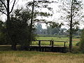 English: Meadows separating two parts of the village, wooden bridge over the Barbarka River Polski: Łąki pomiędzy dwoma częściami wsi, drewniany most przez rzekę Barbarkę