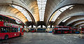 Image 4 Stockwell Garage Photograph: David Iliff An interior view of Stockwell Garage, a large bus garage in Stockwell, London, designed by Adie, Button and Partners and opened in 1952. The 393-foot-long (120 m) roof structure, seen here, is supported by ten very shallow "two-hinged" arched ribs, between which are cantilevered barrel vaults topped by large skylights. The garage, which could originally hold 200 buses, has been a Grade II* Listed Building since 1988. More selected pictures