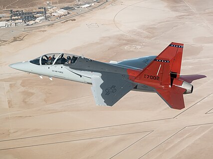 The first T-7A Red Hawk, piloted by USAF test pilot Maj. Jonathan “Gremlin” Aronoff and Boeing test pilot Steve “Bull” Schmidt, soars over Edwards Air Force Base, California, Nov. 8, prior to arrival.