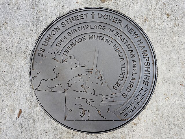 A faux manhole cover commemorating the original site of Mirage Studios in Dover, New Hampshire