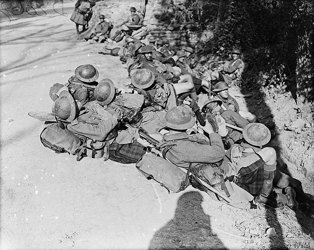 Troops of the Highland Light Infantry resting by the roadside on the way up to attack, 24 September 1917.