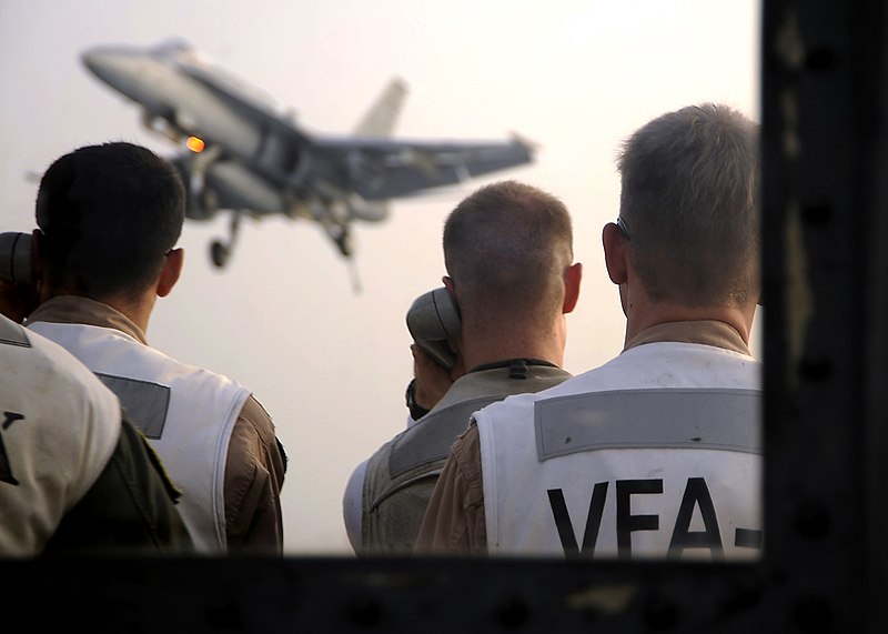 File:US Navy 081016-N-7571S-011 Landing signal officers communicate with the pilot of an F-A-18 Hornet as he approaches the flight deck for an arrested landing aboard the aircraft carrier USS Theodore Roosevelt (CVN 71).jpg