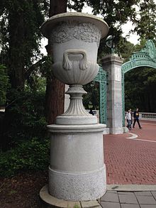 Grey granite campana urn with oak and laurel leaves victor ludorum carving c. 1908 on the Sather Gate at UC Berkeley Urn-sather-gate-berkeley.jpg