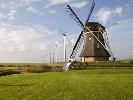 Windmill 'Goliath' in Eemshaven among modern wind turbines.
