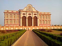 A replica of a beautiful ancient monument surrounded by lush green gardens..jpg