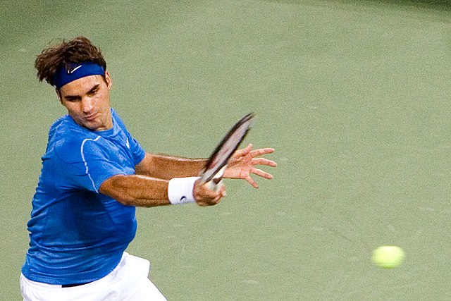 Federer hits a forehand at the 2006 US Open, where he became the first man in history to achieve the Wimbledon-US Open double for three consecutive se