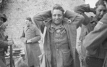 German prisoners & their North Shore guards in Langrune-sur-Mer, France on June 7, 1944 Canadian Forces in the Normandy Campaign 1944 B5144.jpg