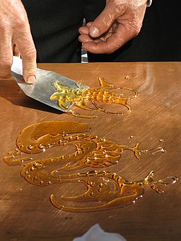 Sugar painting is a traditional Chinese form of folk art using hot, liquid sugar to create two-dimensional figures.
