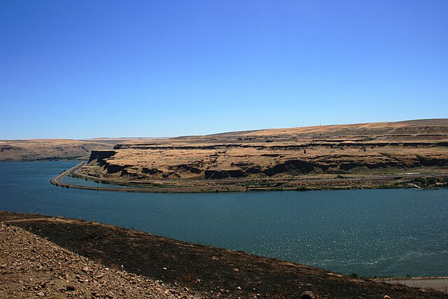 Extensive erosion is visible across the river from Wishram near the mouth of the Deschutes River. Note the interstate highway along the far side of th