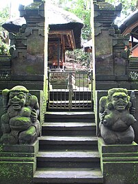A pair of male and female dvarapalas guarding gate of a Hindu temple in Bali, Indonesia.