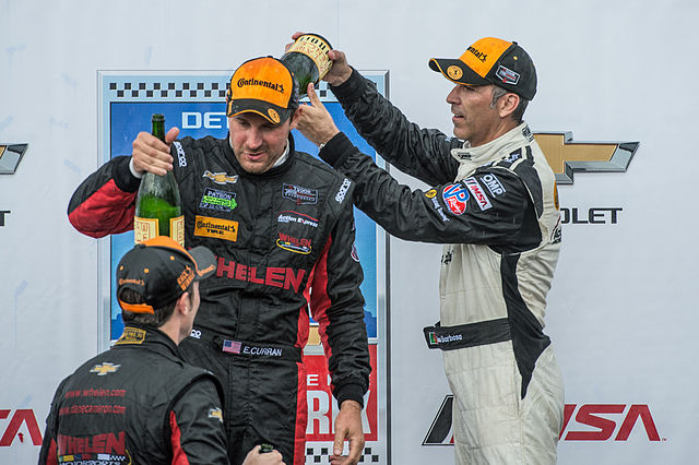 Teammate João Barbosa pours champagne on Eric Curran in celebration of Eric's first win in the Tudor United SportsCar Championship.