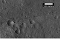 Aproximação de uma falha em Mare Acidalium, visto pela HiRISE sob o programa HiWish. Um círculo ao redor da cratera destaca que esta pode ter tido sua forma alterada devido ao movimento da falha. Muitas outras falhas estão presentes na região.