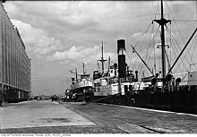 View of freighters at dock and terminal building, 1936 Freighters unloading at Terminal Warehouse dock.jpg