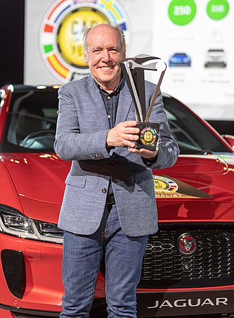 Jaguar Chief of Design Ian Callum holds the Car of the Year 2019 trophy for the Jaguar I-Pace