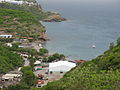 A view of half of the coastline of Little Bay, and a glimpse of Carrs Bay, taken from partway up the headland between Little Bay and Rendezvous Bay, on the island of Montserrat in 2012