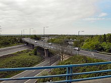 Part of the Swinton Interchange, showing carriageways of the M61-to-M60 spur crossing the M60 (left) and the A580-to-M60 link road (centre) M61 Worsley Braided Interchange, Clifton Moss - geograph.org.uk - 2382867.jpg