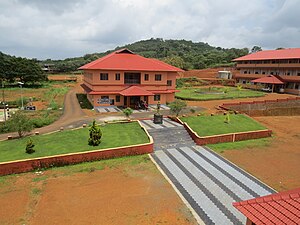 One of the college buildings, Mahathma Gandhi statue can be seen Mahathma Gandhi College, Iritty (7).jpg