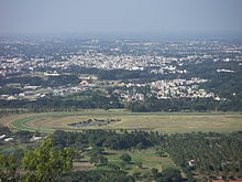 View of the city from Chamundi Hills Mysore race course.jpeg