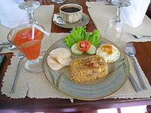 Nasi goreng breakfast in a hotel in Solo, Central Java, with papaya juice and Java black coffee. Nasi Goreng Breakfast Set in Solo.JPG