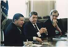 President Reagan (center) receives the Tower Commission Report in the White House Cabinet Room; John Tower is at left and Edmund Muskie is at right, 1987. Photograph of President Reagan receiving the Tower Commission Report in the Cabinet Room - NARA - 198581.jpg