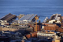 Solar panels are visible on the roof at Pier 15 Pier 9 and Pier 15 with construction crane - San Francisco.JPG