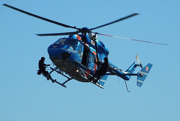 Saitama Prefectural Police Riot And Tactics Squad (RATS) officers on the side of a police helicopter. Riot Police Units such as RATS are the rapid rea