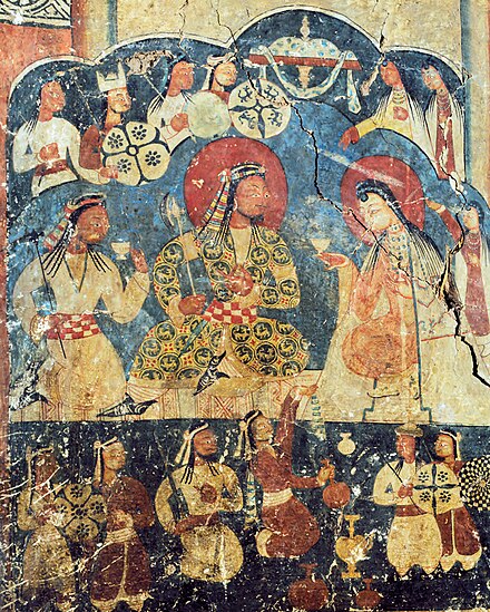 Royal drinking scene at Alchi Monastery, Ladakh, circa 1200 CE. The king wears a decorated Qabā', of Turco-Persian style. It is similar to another royal scene at nearby Mangyu Monastery.[36]