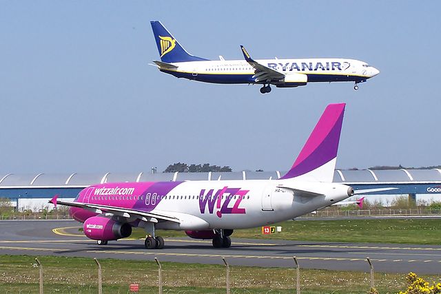 Ryanair and Wizz Air airplanes at Glasgow Prestwick Airport. The airlines are two competing low-cost carriers in the European market.