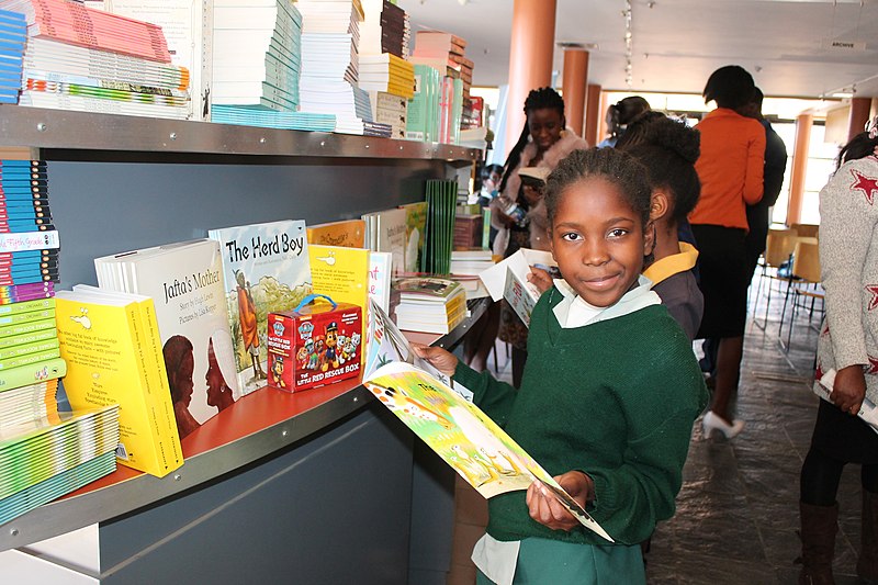 File:School girl going through textbooks, Namibia (39590282232).jpg