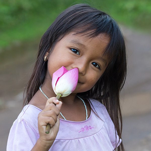 File:Smiling girl holding a lotus flower.jpg