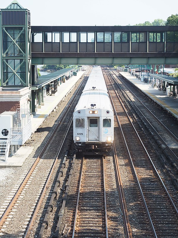 Southbound Metro North train passing through Riverdale station. Looking north from 254th street bridge.