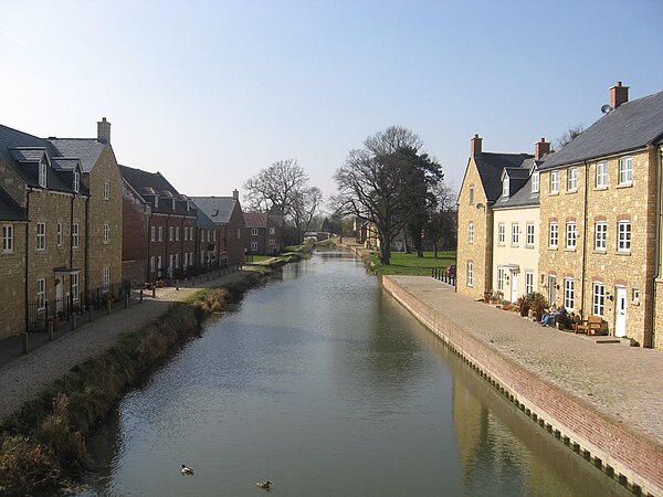 The restored canal to the west of Ebley Mill is flanked by a new housing development.