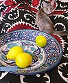 Tajik blue ceramic dish, suzani and a cat by Parvision