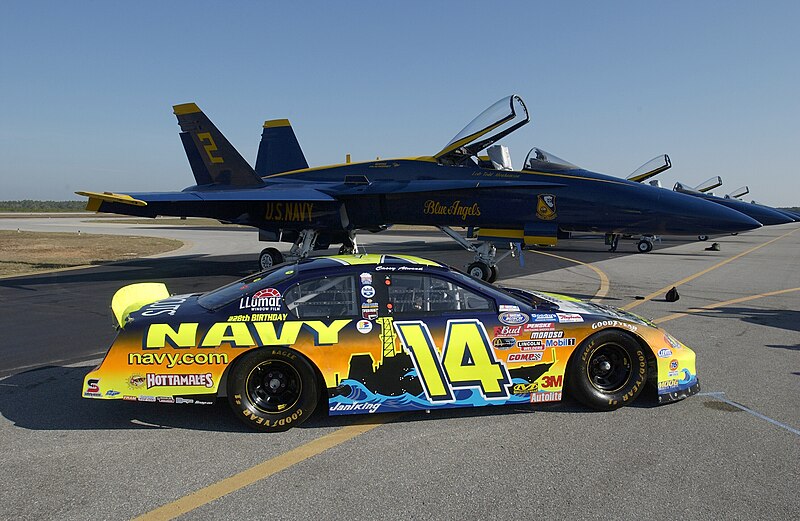 File:US Navy 031108-N-5862D-008 The Navy sponsored Chevrolet Monte Carlo Busch Series race, show car is parked on the tarmac near F-A-18 Hornets assigned to the Navy's flight demonstration team, the Blue Angels, at Sherman Field.jpg