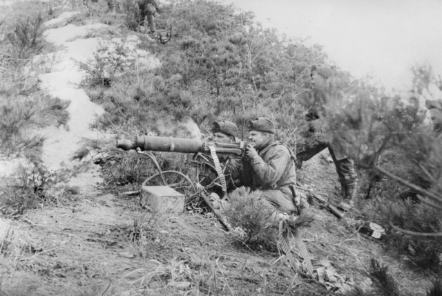 Australian soldiers firing a Vickers machine gun.