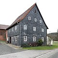 Two-storey half-timbered house with a gable roof