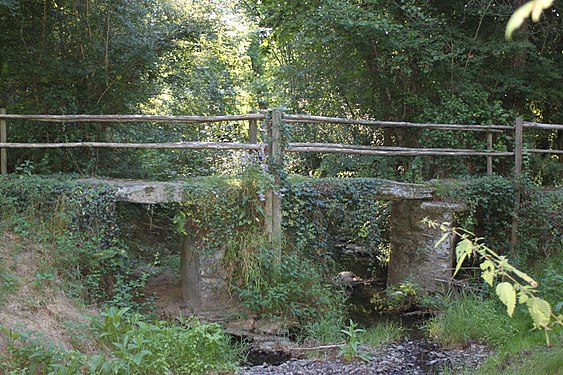 Old stone bridge over Ilette river at Saint-Sauveur-de-Landemont, France.