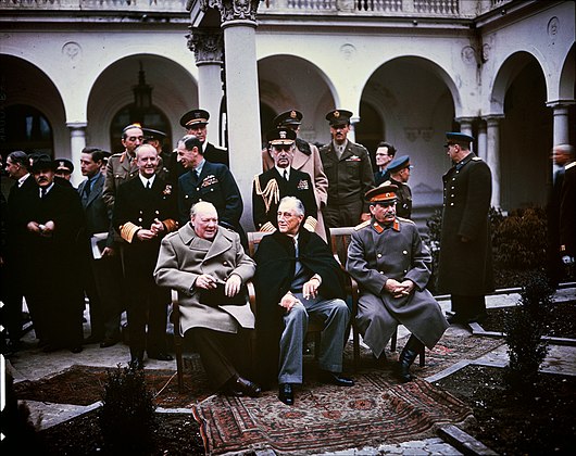 From left to right: Winston Churchill, Franklin D. Roosevelt, and Joseph Stalin. Also present are Soviet Foreign Minister Vyacheslav Molotov (far left); Field Marshal Sir Alan Brooke, Admiral of the Fleet Sir Andrew Cunningham, RN, Marshal of the RAF Sir Charles Portal, RAF, (standing behind Churchill); General George C. Marshall, Chief of Staff of the United States Army, and Fleet Admiral William D. Leahy, USN, (standing behind Roosevelt).