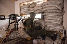 A Separatist looking though firing port at his position near Donetsk, May 2015 A Russia-backed rebel looking though firing port at his position near Donetsk, Eastern Ukraine, May 26, 2015.jpg