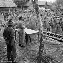Eastick addressing part of the parade at the surrender ceremony at the camp, 11 September 1945 Awm116933.jpg