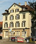 Residential house and city wall (including an outdoor sculpture with a soldier and horse)