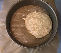 Prepare dough for a cake layer on buttered baking paper