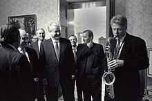 Clinton plays the saxophone presented to him by Russian president Boris Yeltsin at a private dinner in Russia, January 13, 1994 Bill Clinton and Boris Yeltsin 1994.jpg